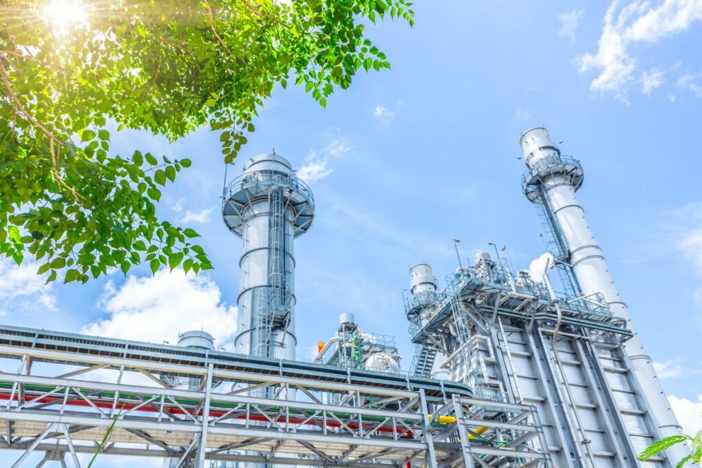 a large factory with towers and pipes